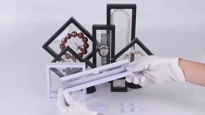 Reusable display frames for jewelry, gemstones, figures and coins in a floating look available in various sizes from 5cm side length to 23cm side length in white and black